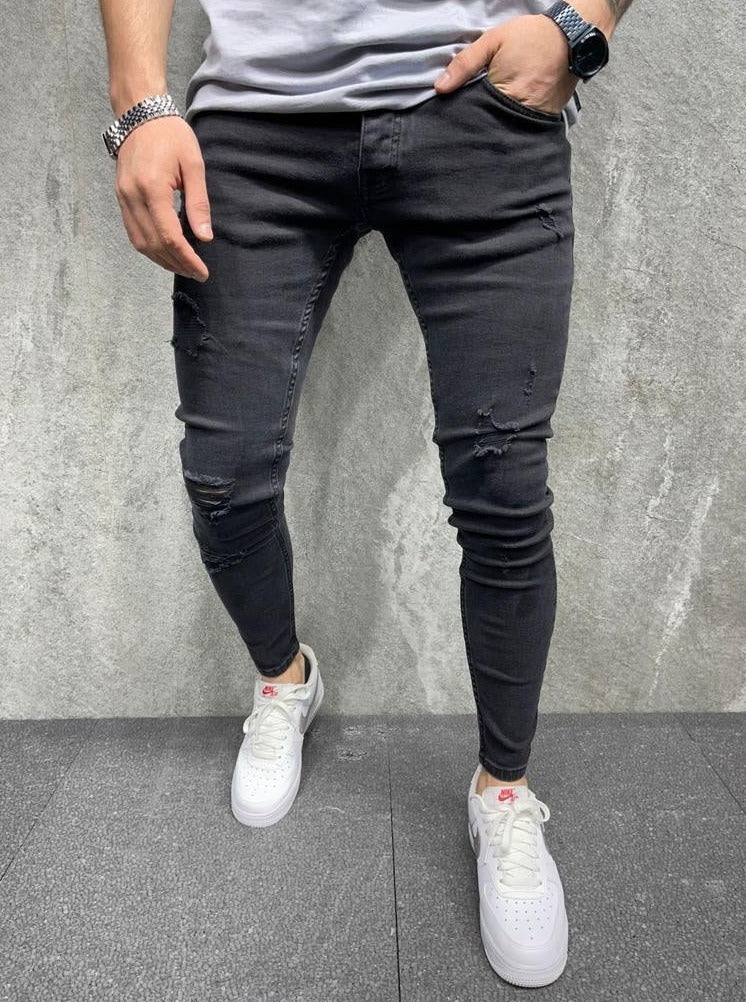 Jeans noir skinny fashion avec déchirures homme